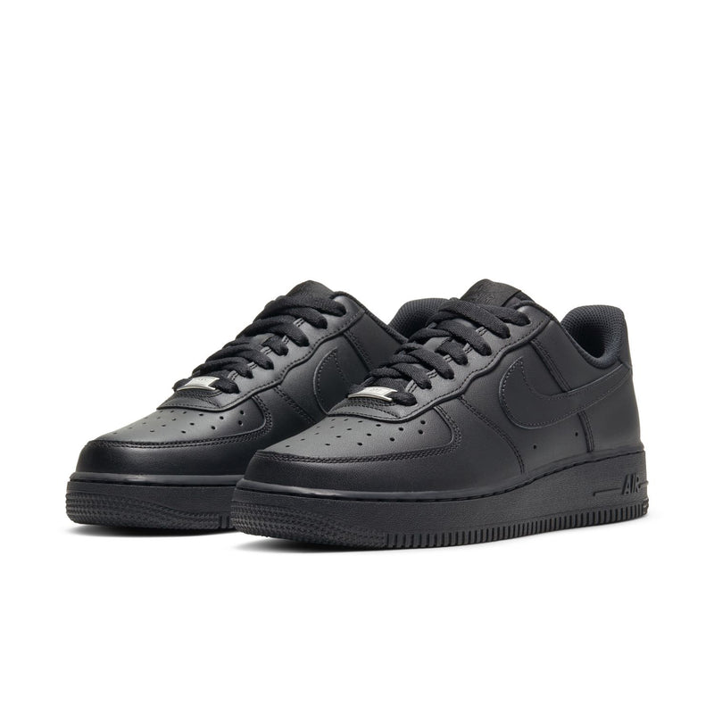 Pair of black women’s low-top sneakers, side profile with lace-up design
