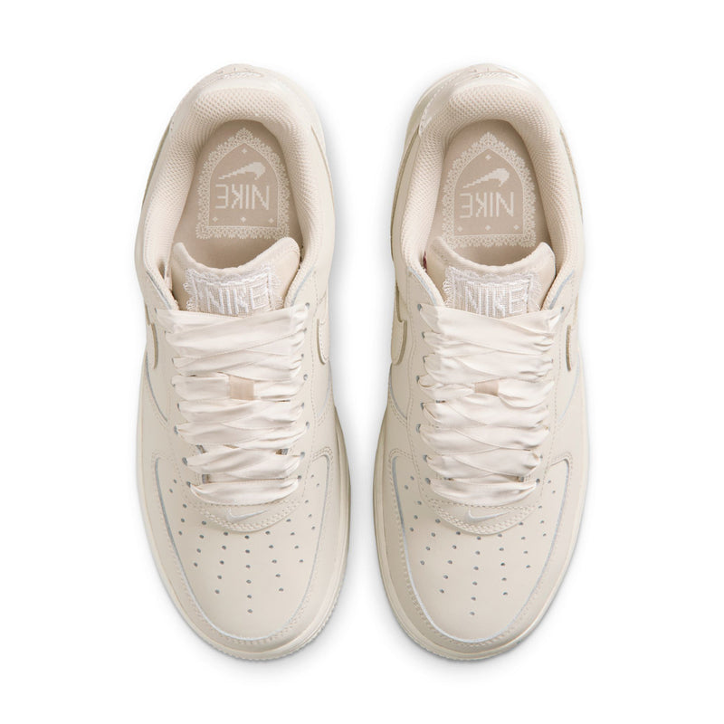 Women's Nike Air Force 1 sneakers top view, light oatmeal with Nike logo on tongue