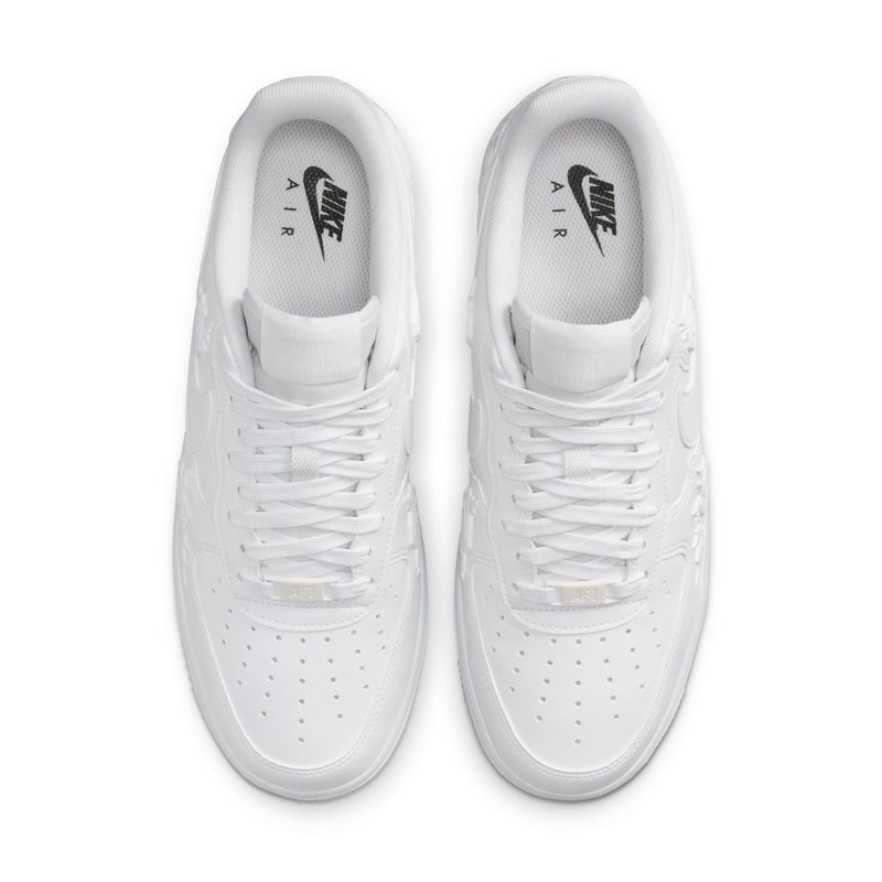 Women's Nike white sneakers, top view showing laces and logo on insoles
