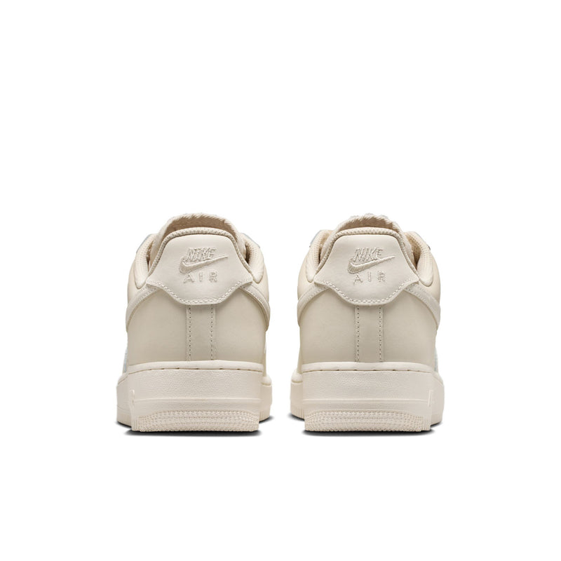 Women's Nike Air Force 1 heel view, light oatmeal with rear pull tab and Nike logo