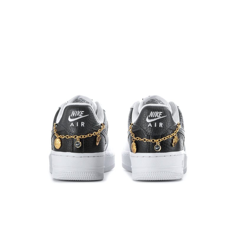 Women's black-and-white sneakers with gold chain at heel and white rubber outsole