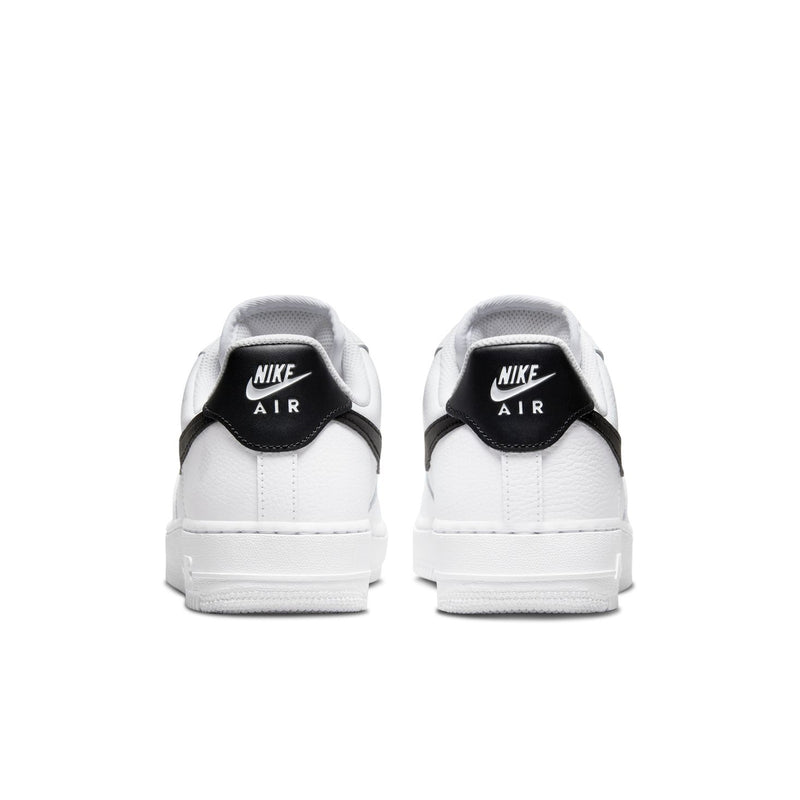Women’s white low-top sneakers from the heel view with black collar trim