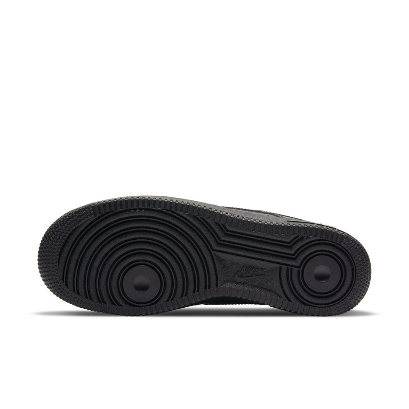 Black outsole of women’s low-top sneakers with circular traction pattern