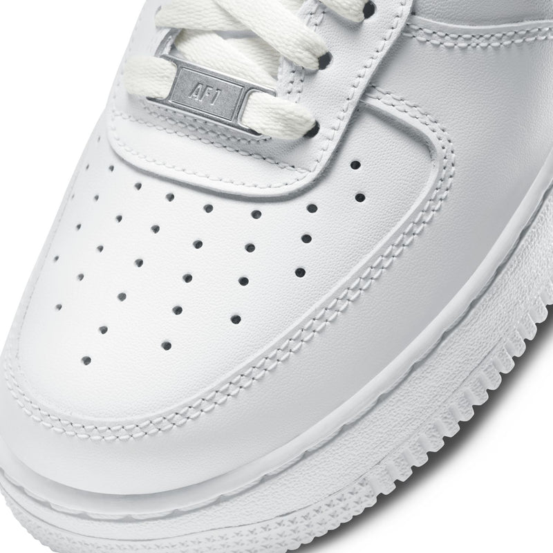 Women's white sneaker upper close-up, perforated toe and stitched panels