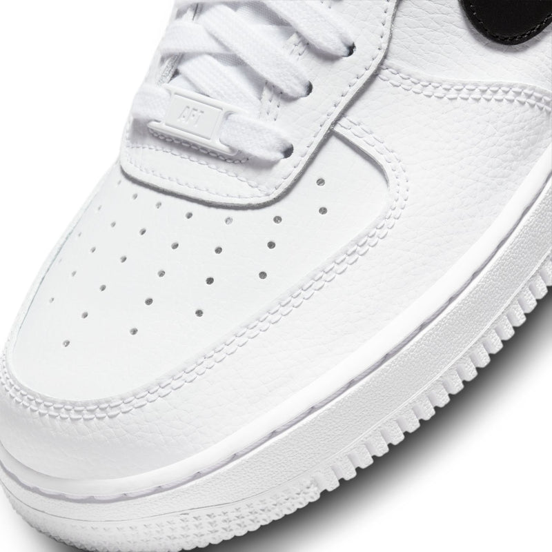 White sneaker toe and lace panel detail with perforations and textured leather