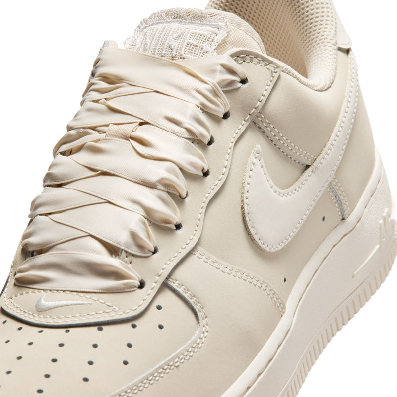 Women's Nike Air Force 1 lace-up sneaker in light oatmeal, suede overlays and swoosh