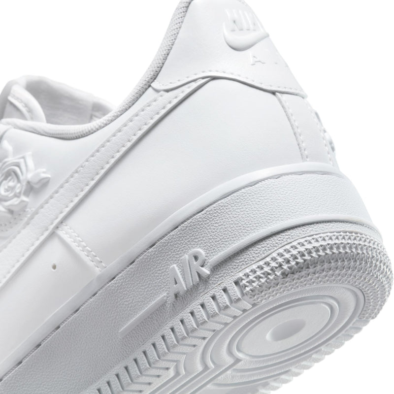 Women's Nike white sneaker close-up of heel and outsole with 'AIR' midsole text