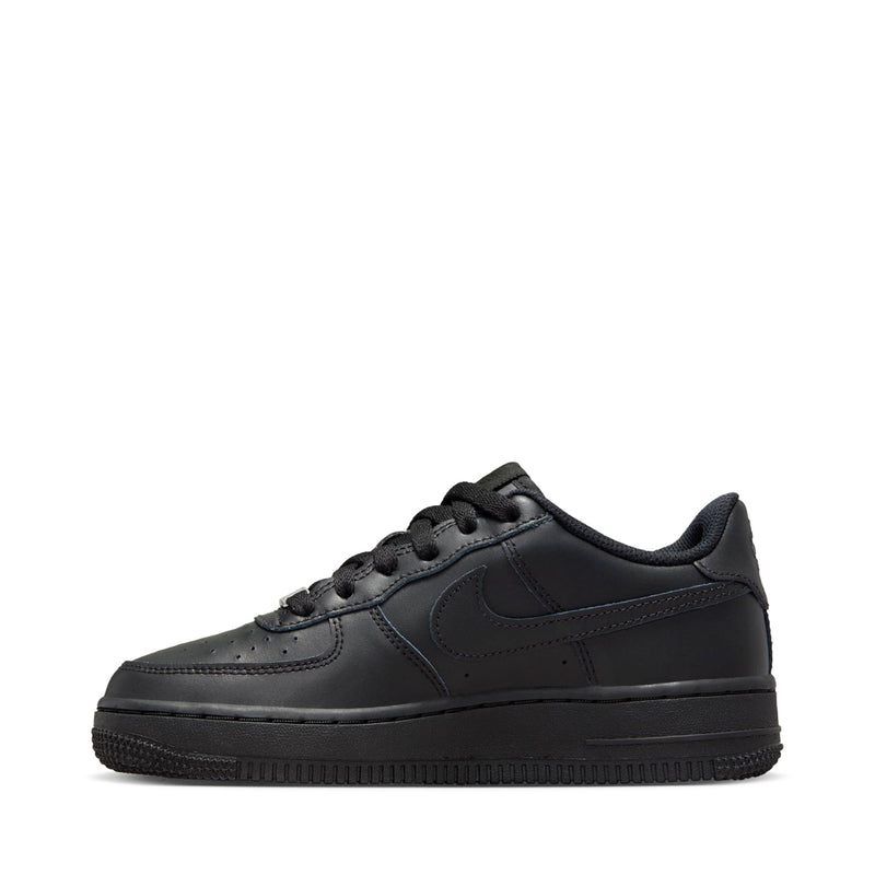 Black Nike youth low-top sneakers, side view showing swoosh and lace-up design