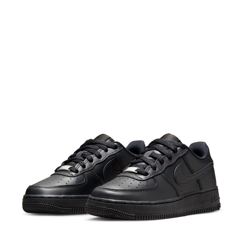 Black Nike youth low-top sneakers, pair view with lace-up and stitched toe box