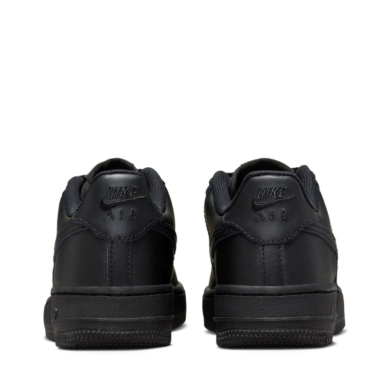 Black Nike youth low-top sneakers, rear view with Air branding on heel