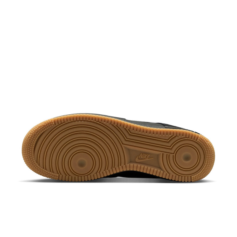 Brown gum rubber outsole with Nike logo and circular traction pattern.