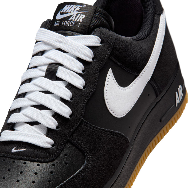 Black upper with white swoosh, white laces, and Nike Air tongue patch detail.