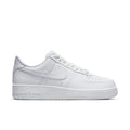 White low-top sneakers with Nike swoosh, perforated toe, and lace-up closure