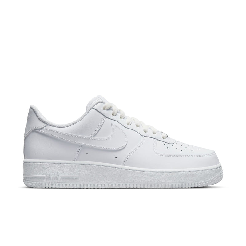 White low-top sneakers with Nike swoosh, perforated toe, and lace-up closure