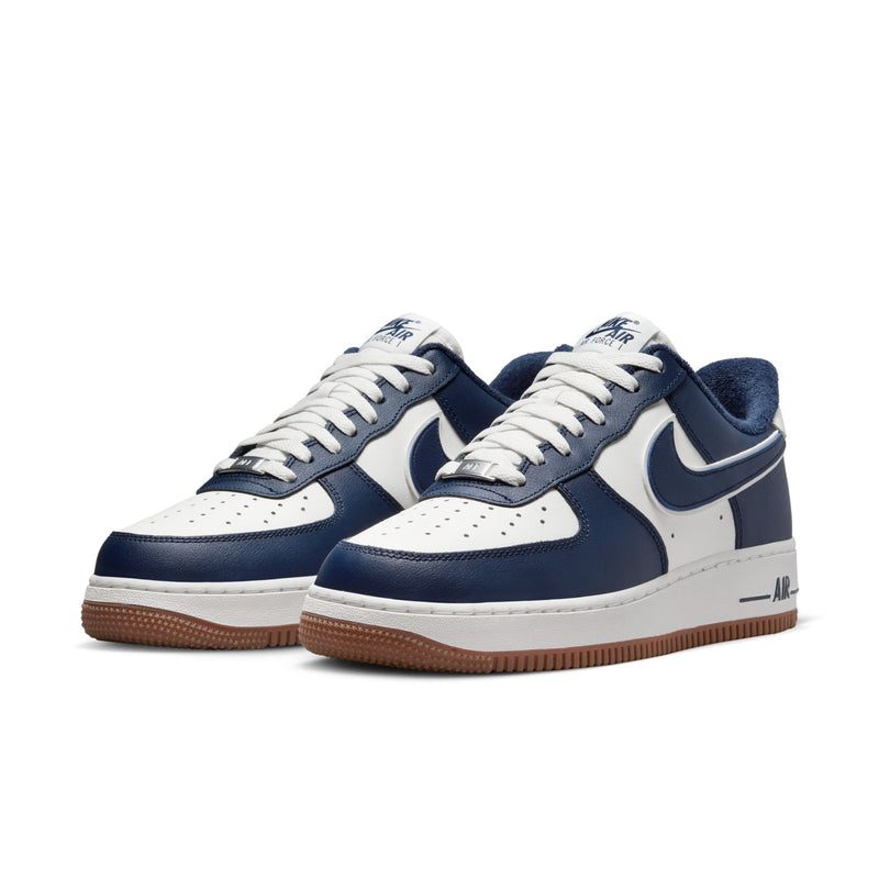 Pair of low-top sneakers, navy and white uppers, white laces, gum outsole