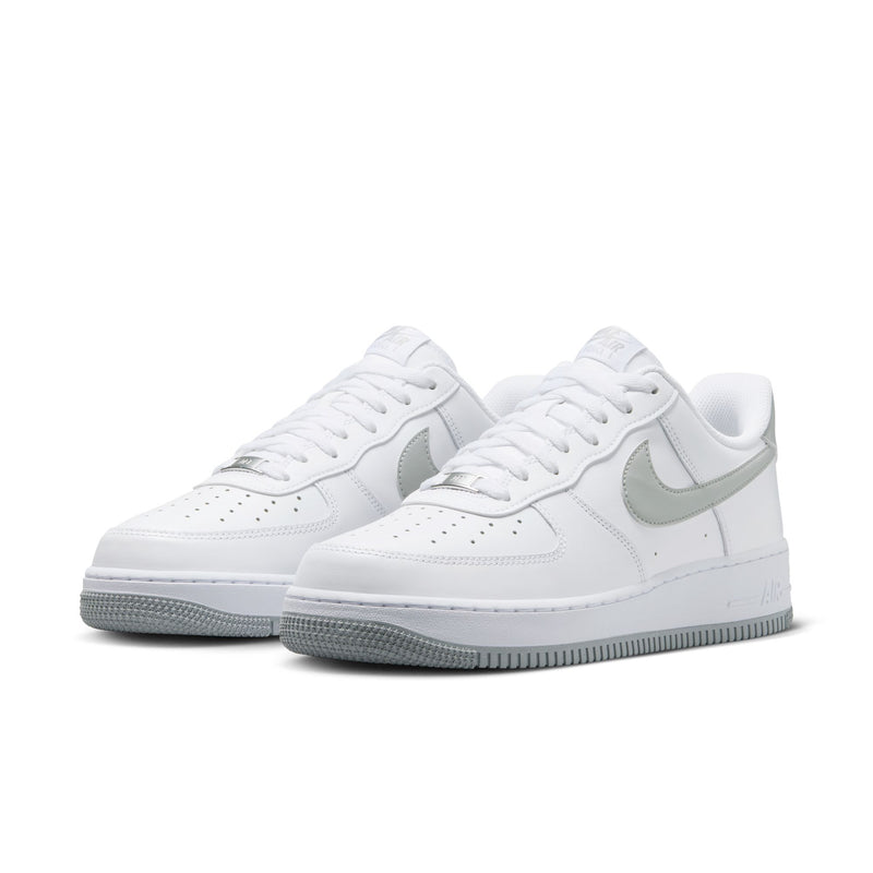 Pair of men's white low-top sneakers with light smoke gray swoosh and gray outsole