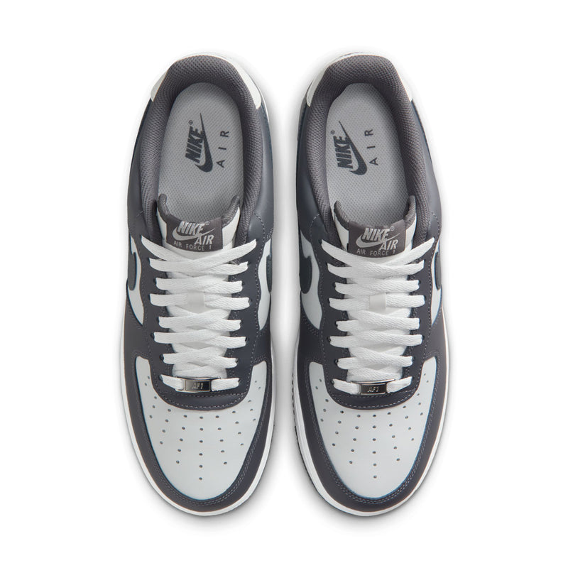 Men's sneakers showing two white laces and perforated toe in dark grey and white