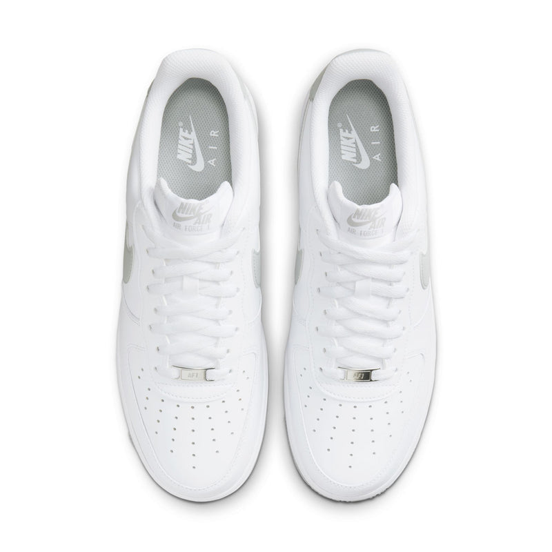 Men's white low-top sneakers with perforated toe and lace-up closure