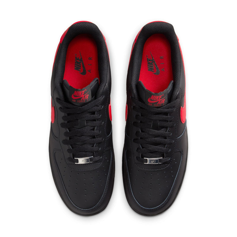 Black low-top Nike sneakers viewed from above, with red interior lining