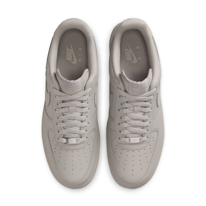 Two light gray sneakers viewed from top with lace-up design and Nike branding