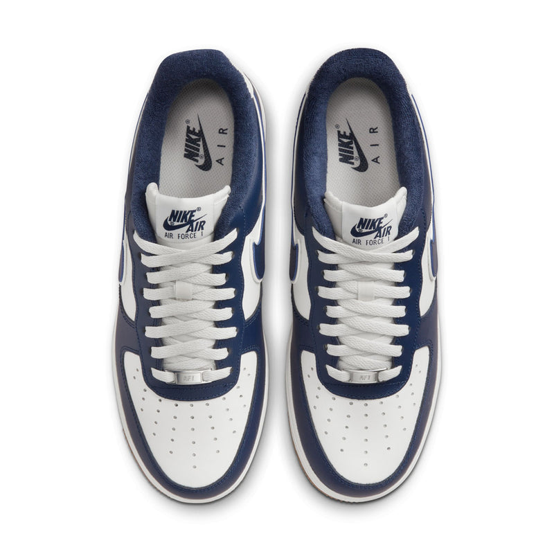 Nike Air sneakers with white laces on navy and white leather upper