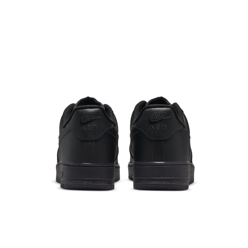 Black low-top sneakers heel view with embroidered branding on the back