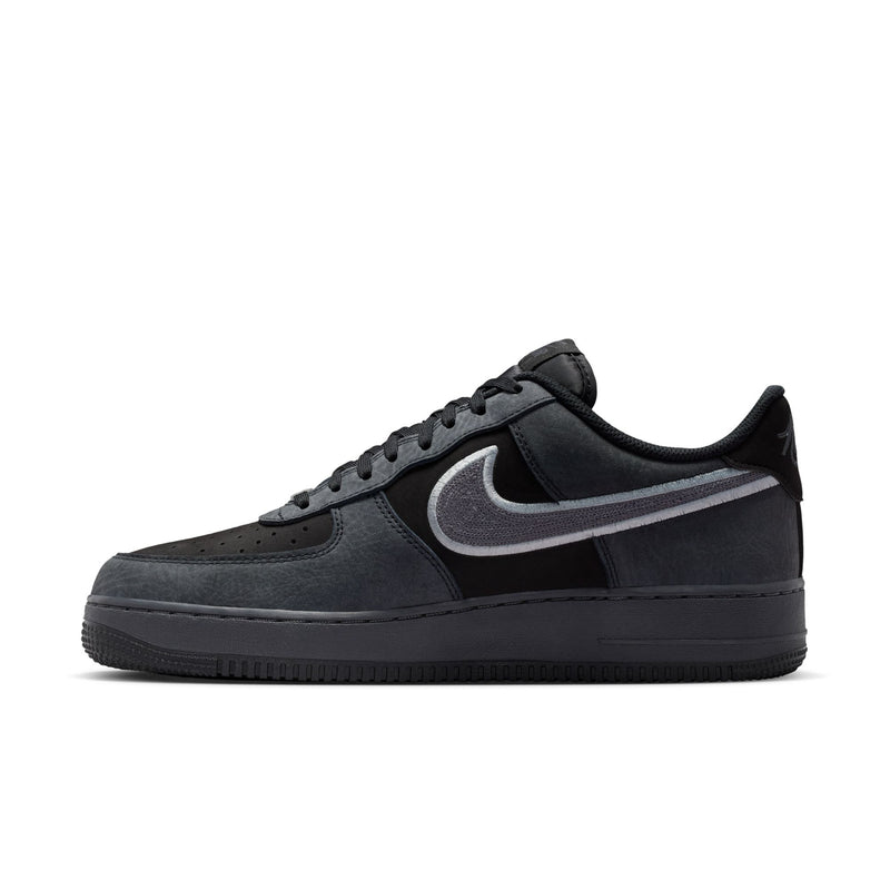 Men's low-top sneakers in black and smoke gray, side profile with Nike Swoosh