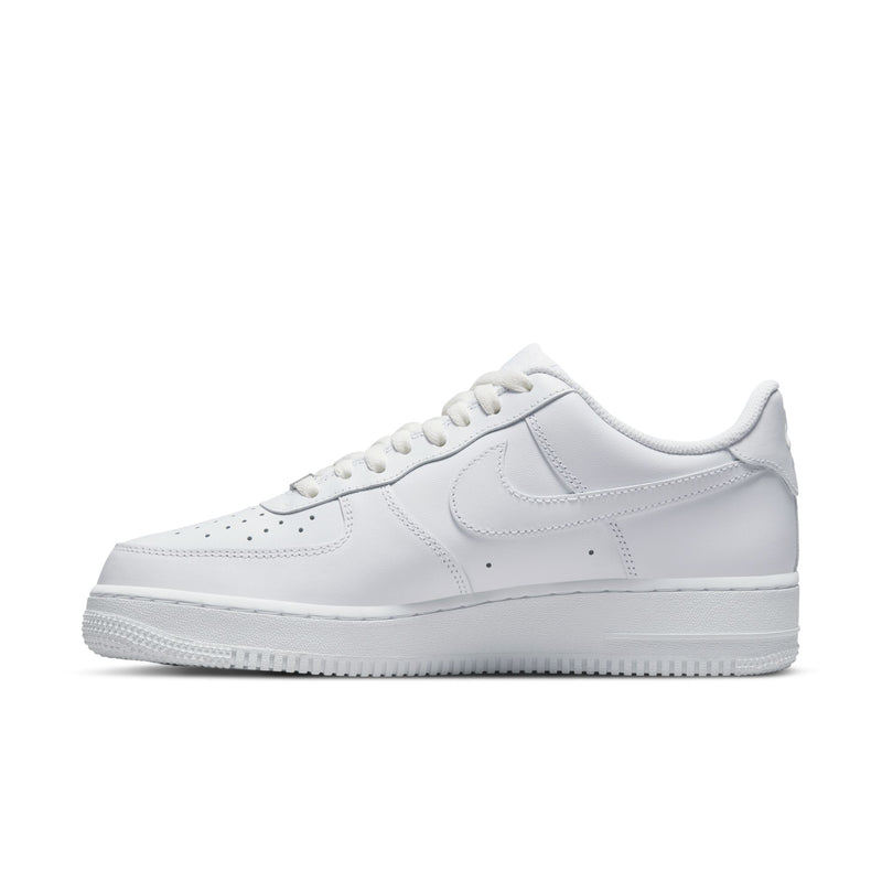 White low-top sneakers with stitched panels, Nike swoosh, and lace-up front