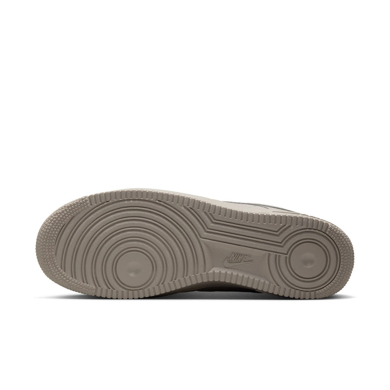 Light gray outsole view of Nike low-top sneakers with detailed tread pattern