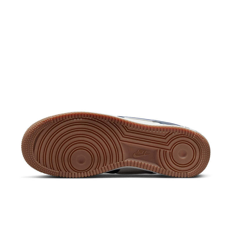 Outsole view of low-top sneakers with brown gum traction tread