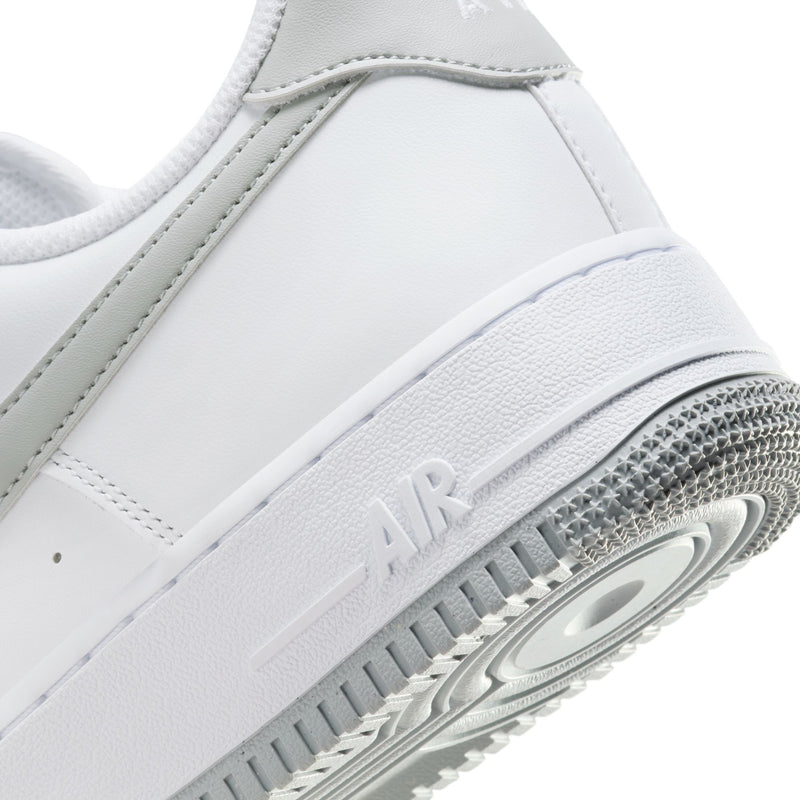 Close-up of men's white sneaker midsole with Air text and textured outsole edge
