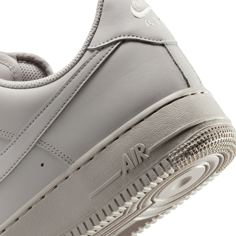 Light gray Nike Air low-top sneaker close-up of outsole tread and side panel