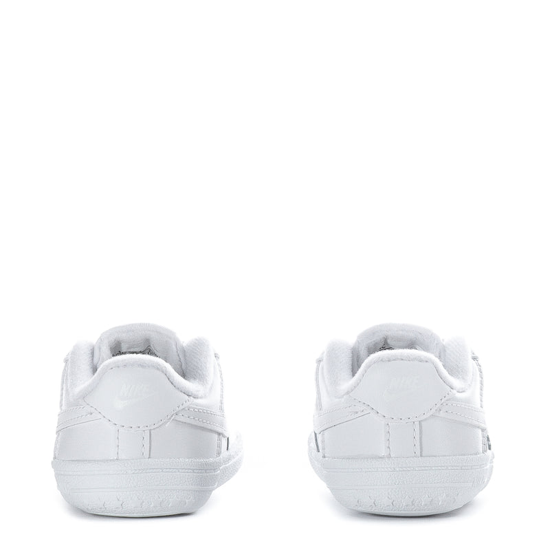 Infant white low-top sneakers with heel tab and lace-up closure