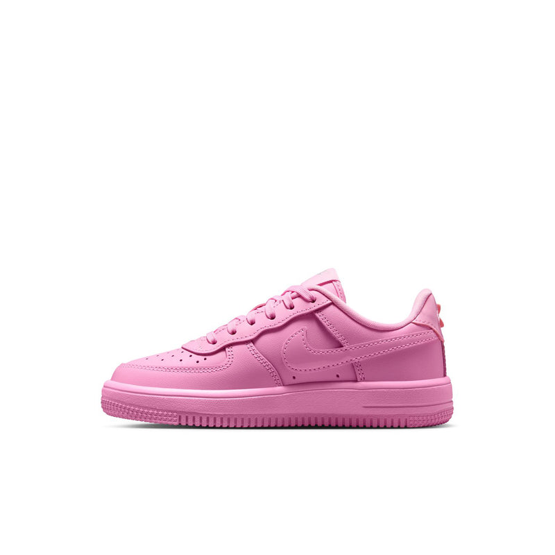 Kids' pink low-top lace sneakers, angled side profile with Nike Swoosh