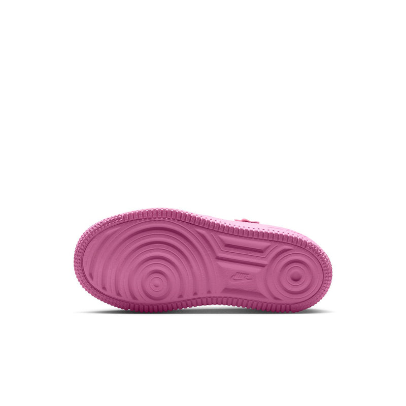 Kids' pink low-top sneakers, rubber outsole view with textured tread
