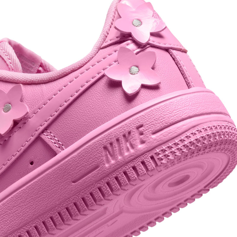 Kids' pink lace sneakers, close-up of Nike Swoosh and flower heel detail