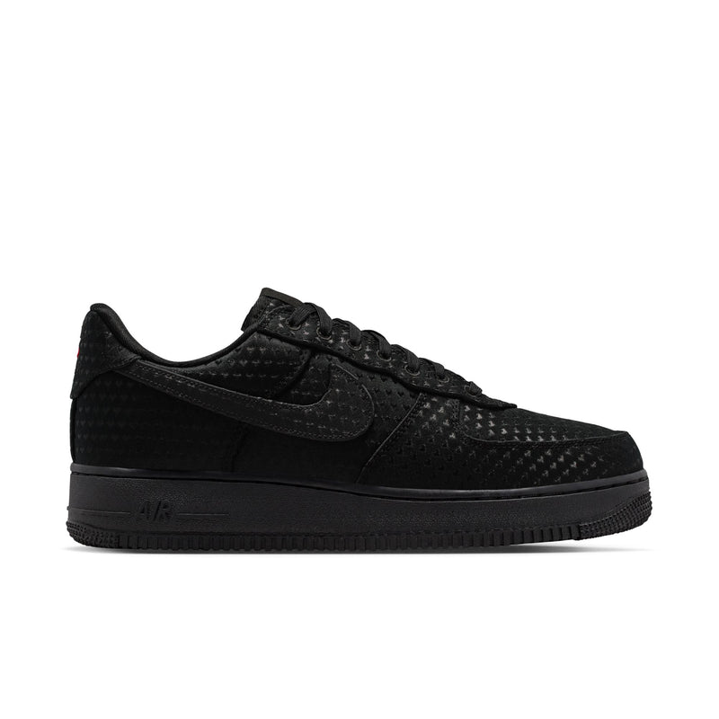 Black low-top sneakers with textured upper, lace-up front, and black rubber sole