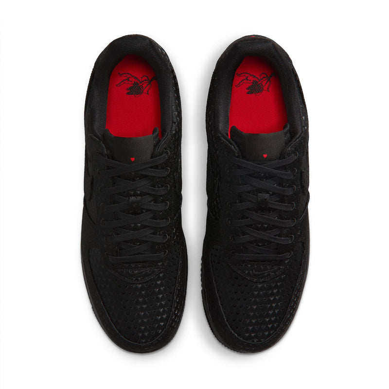 Black low-top sneakers with bright red insoles visible from the top opening