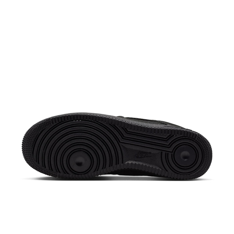 Black sneaker outsole with circular traction pattern and molded rubber texture