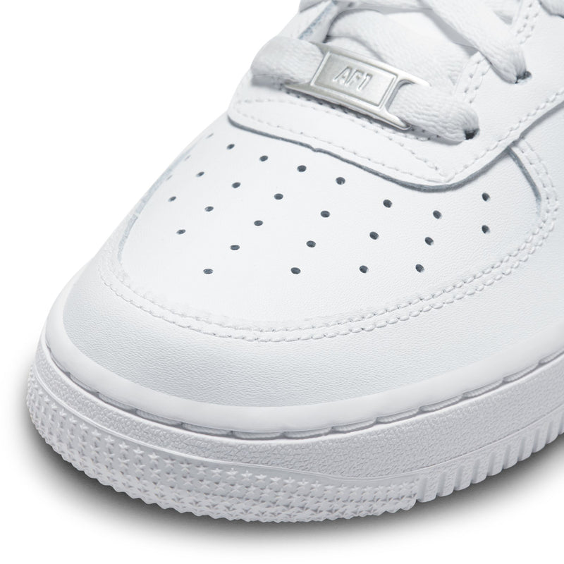 Close-up youth low-top sneaker toe, white leather with perforations and lace-up