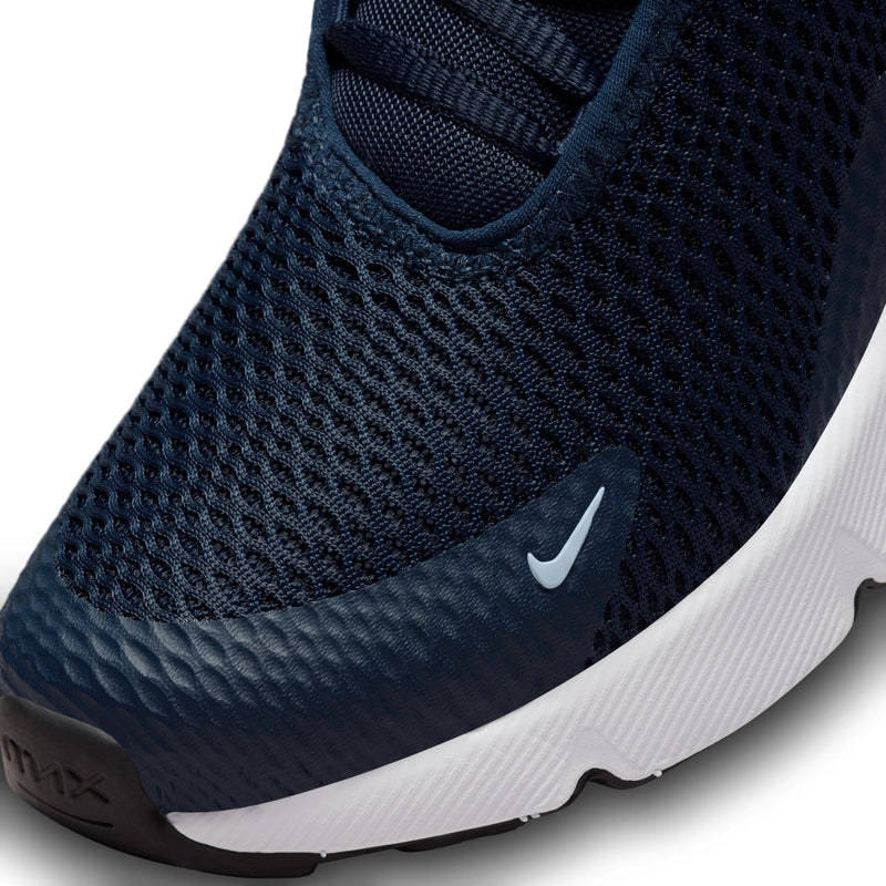 Kids Nike sneaker close-up, navy textured mesh upper with white midsole