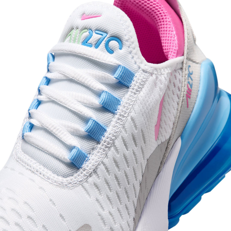 Youth sneaker close-up on white knit upper with blue lace eyelets and pink heel panel