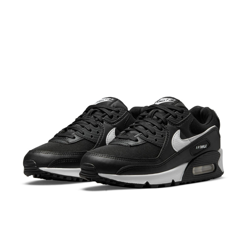 Women's Air Max 90 sneaker pair from side/front, black with white swoosh and air unit.