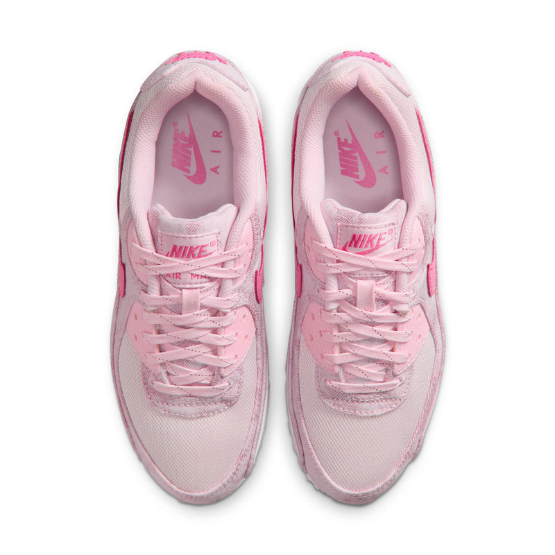 Women's pink lace-up sneakers viewed from above, showing padded tongues and insoles