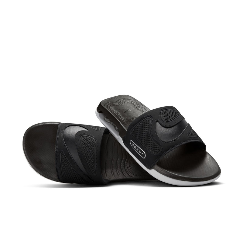 Black Nike slide sandals with molded straps and contoured footbed, white midsole