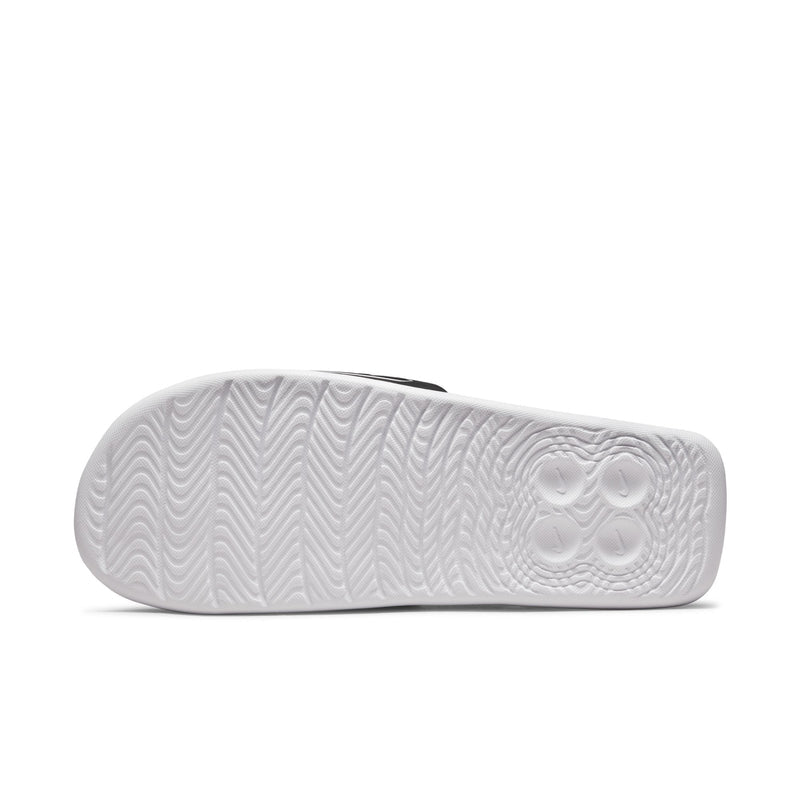 White Nike slide sandal outsole with molded wave traction pattern