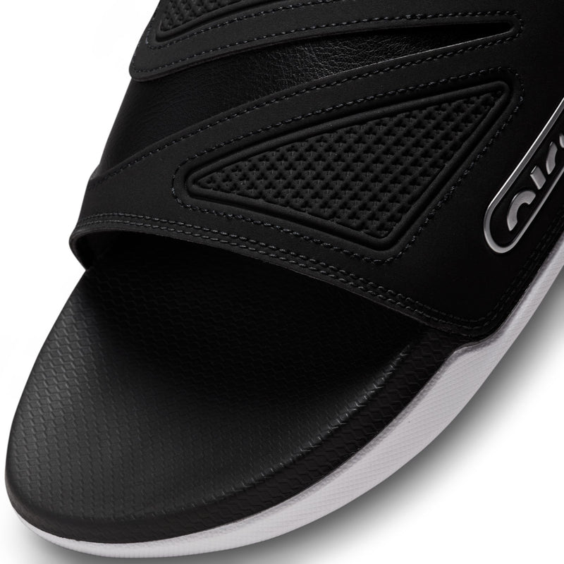 Black Nike slide sandal close-up with perforated strap panel and swoosh logo