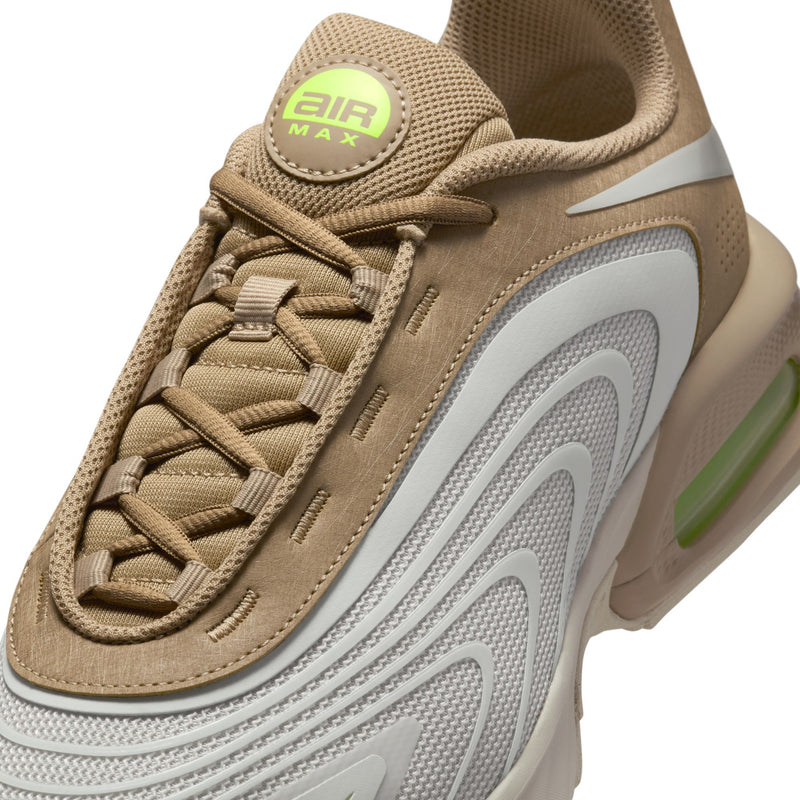 Close-up men's lace-up sneakers: tan mesh, neon green 'Air Max' logo, white swoosh