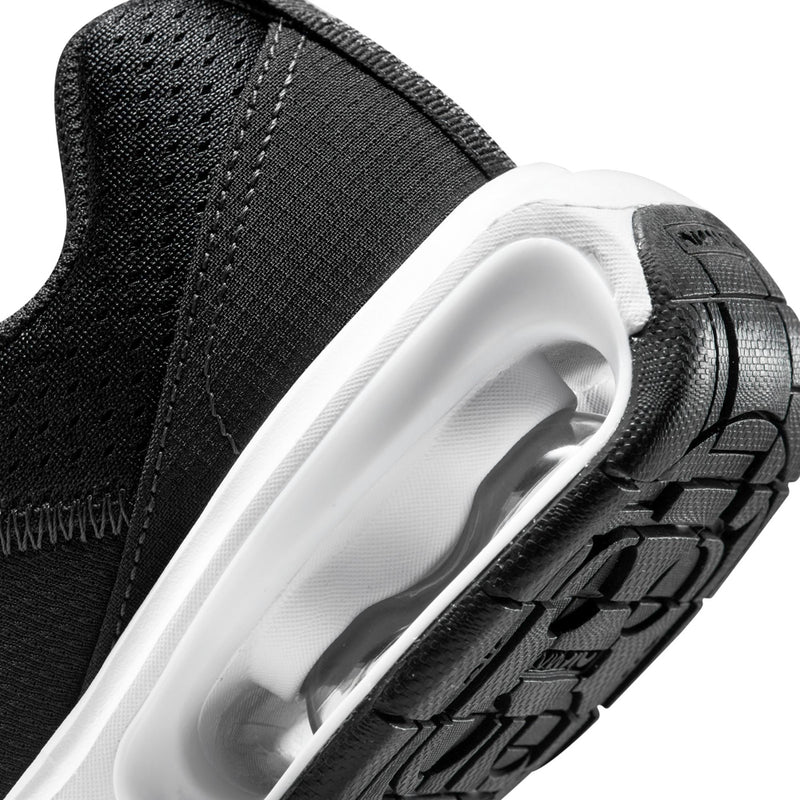 Kids' black sneaker close-up with clear air window and patterned sole grip