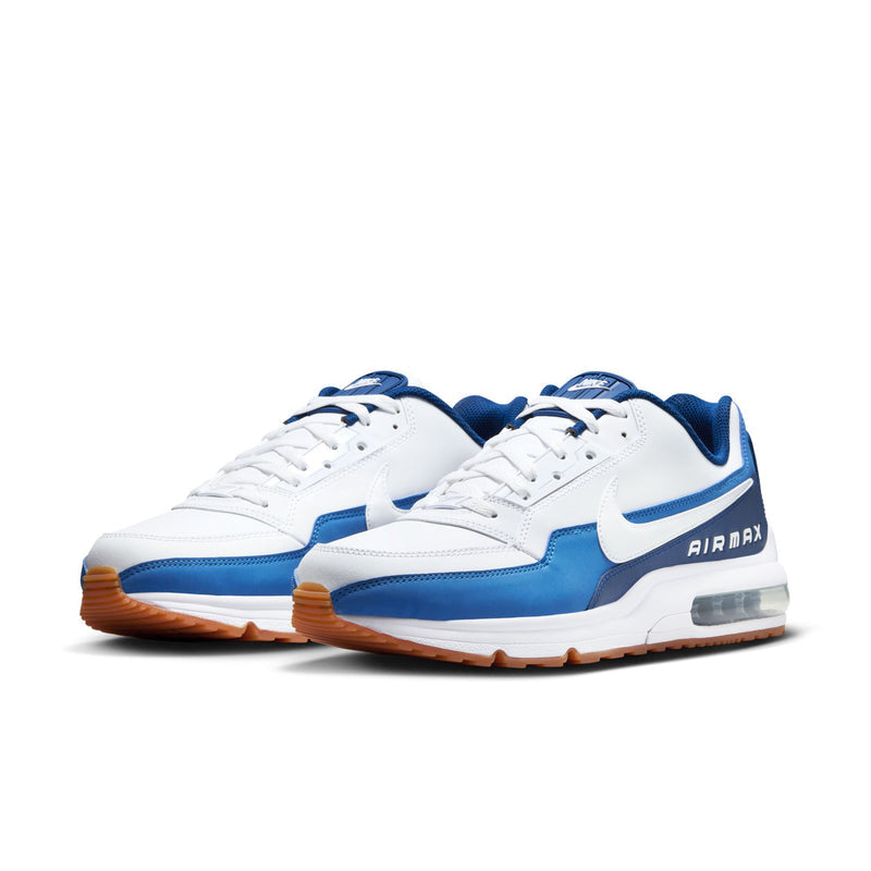 Pair of men's sneakers in white with blue accents, laced front, visible Air window
